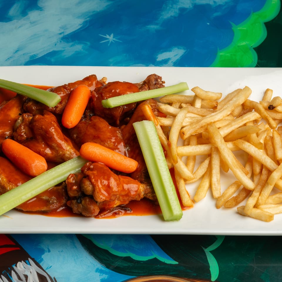 Magueys Mexican Restaurant's buffalo wings with celery, carrots, and a side of french fries.