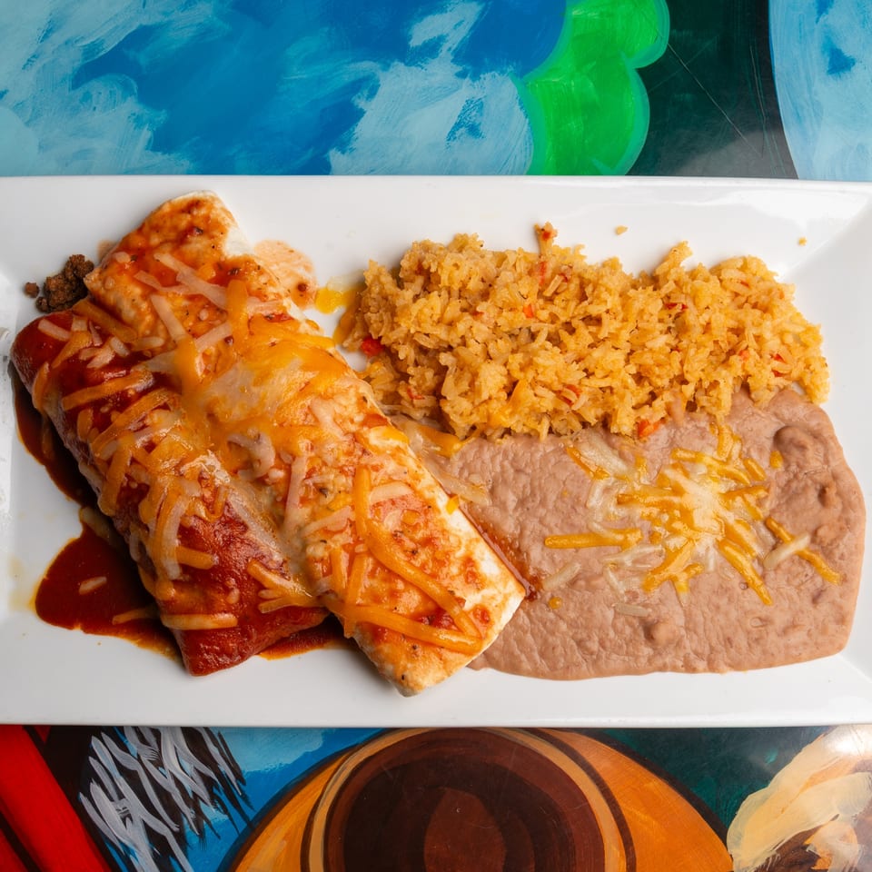Magueys Mexican Restaurant's enchiladas with red sauce and melted cheese, served with rice and refried beans.